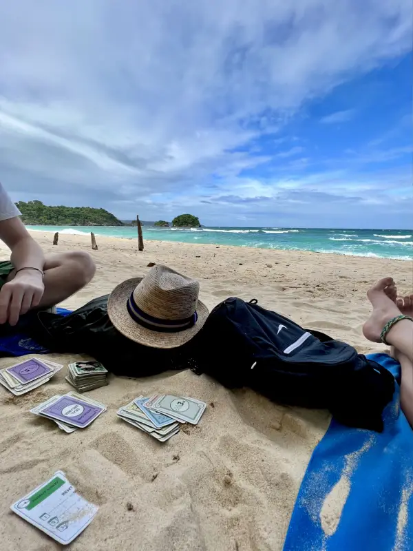 Playing Monopoly at the beach whilst traveling