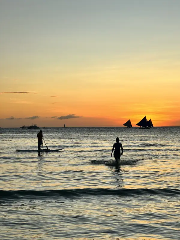 Boracay's incredible sunsets - paddleboarder and person in the ocean